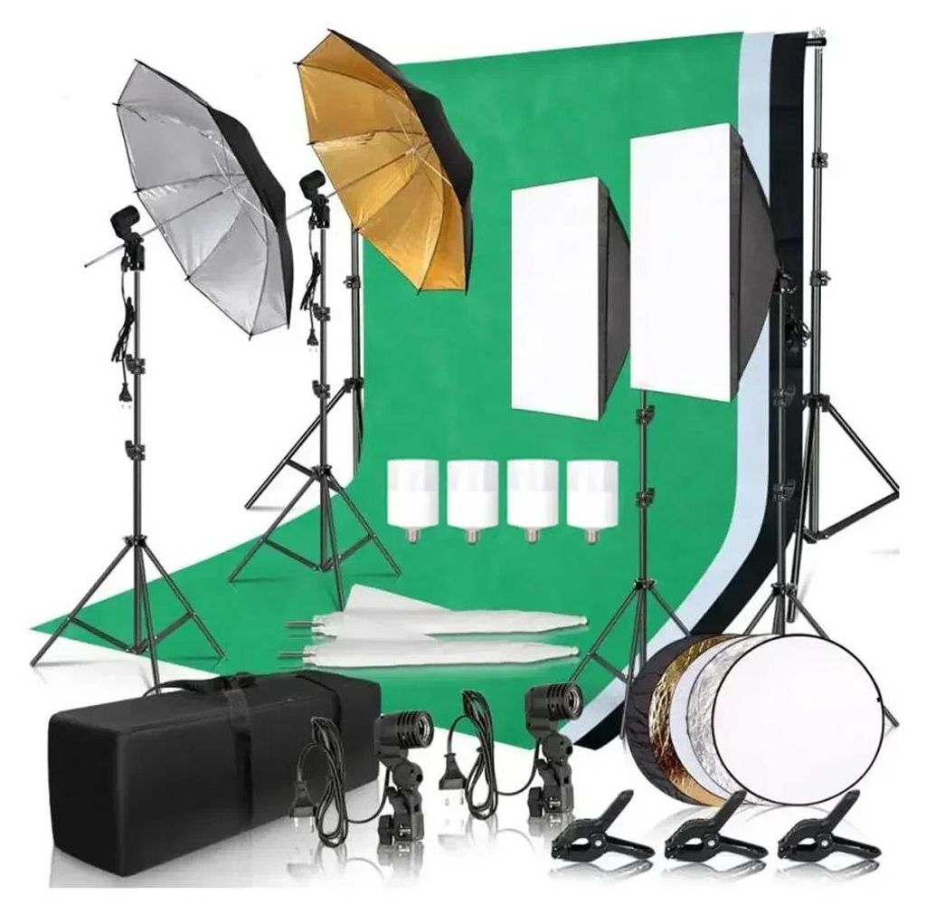 A photography lighting kit is arranged on a green backdrop.