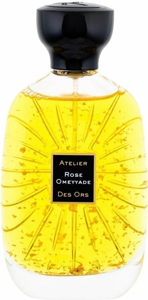 A bottle of perfume with gold flakes inside.