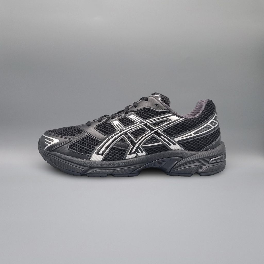 A black and white Asics running shoe is shown against a plain gray background.
