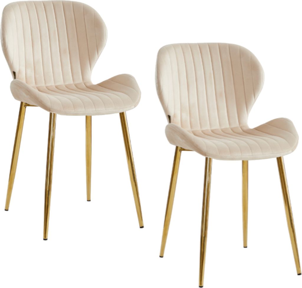 Two beige upholstered dining chairs with gold metal legs are shown against a white background.