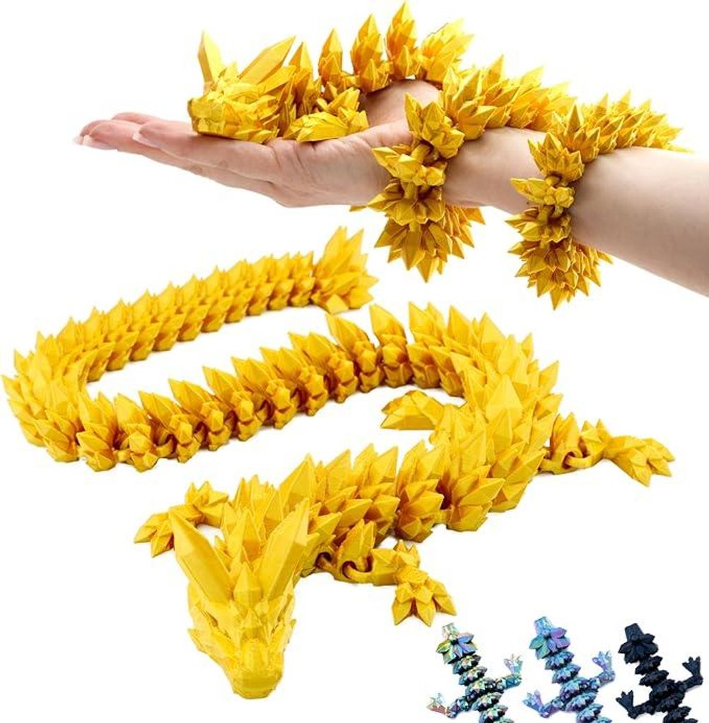 A person's hand and arm are holding a yellow, segmented dragon figurine. Another segmented dragon figurine is laid out on a white surface below. Smaller, multi-colored dragon figurines are in the bottom right corner.