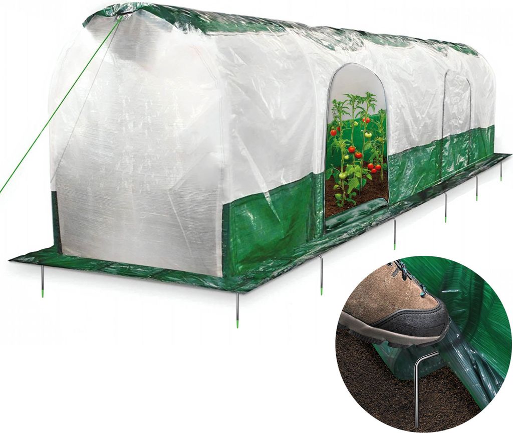 A greenhouse tunnel with plants inside, anchored to the ground.