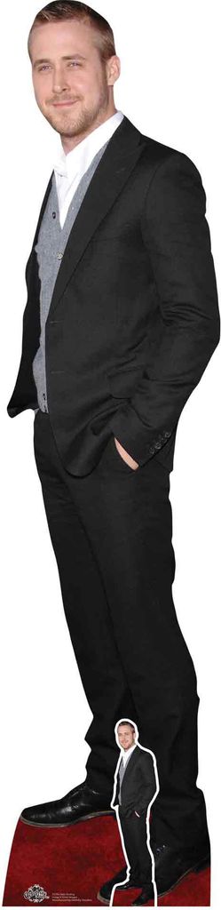 A full-body cardboard cutout of Ryan Gosling in a black suit, standing on a red carpet.
