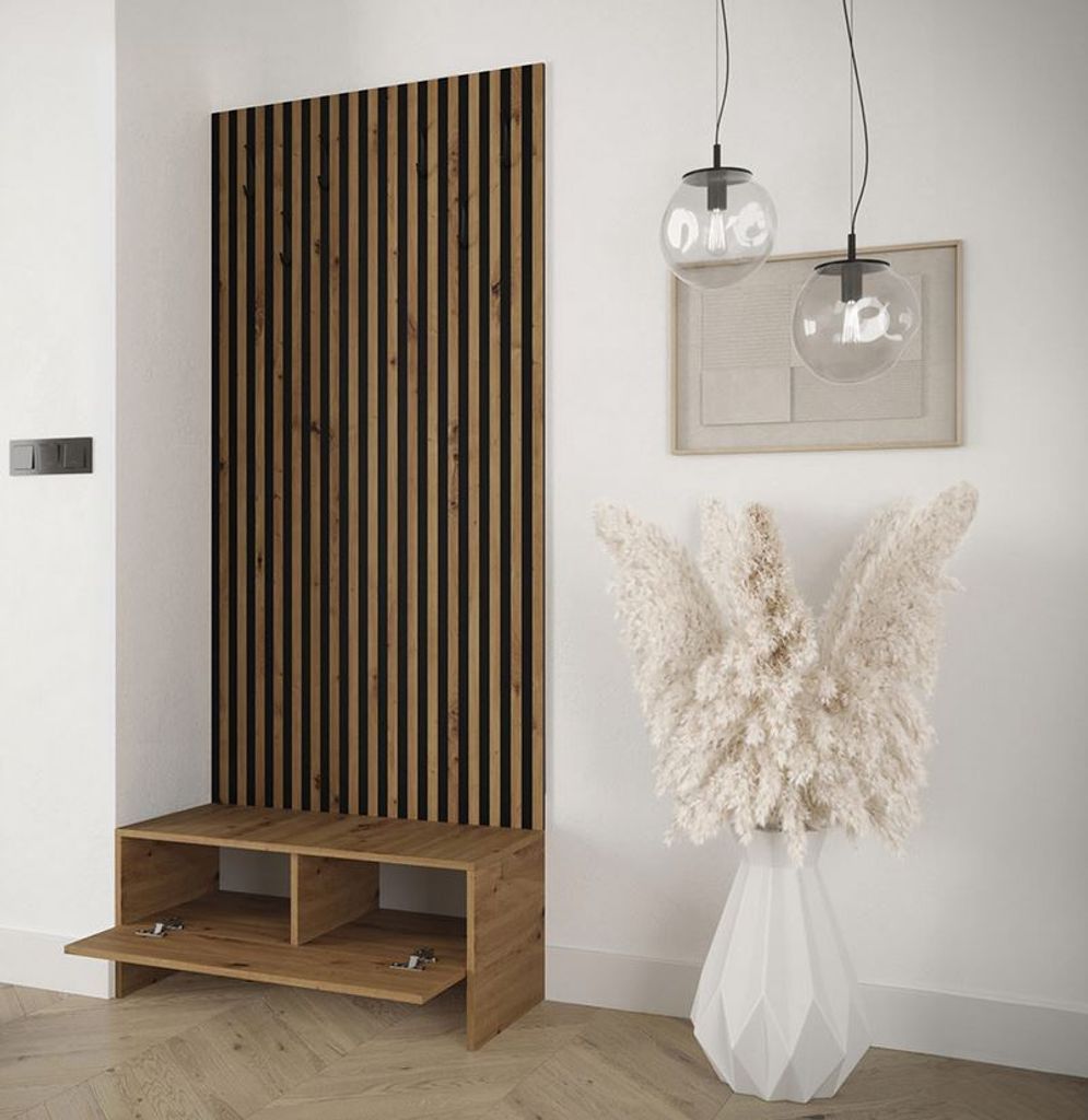 A modern entryway with a wooden slatted panel and a bench with storage, decorated with a large vase of dried flowers.