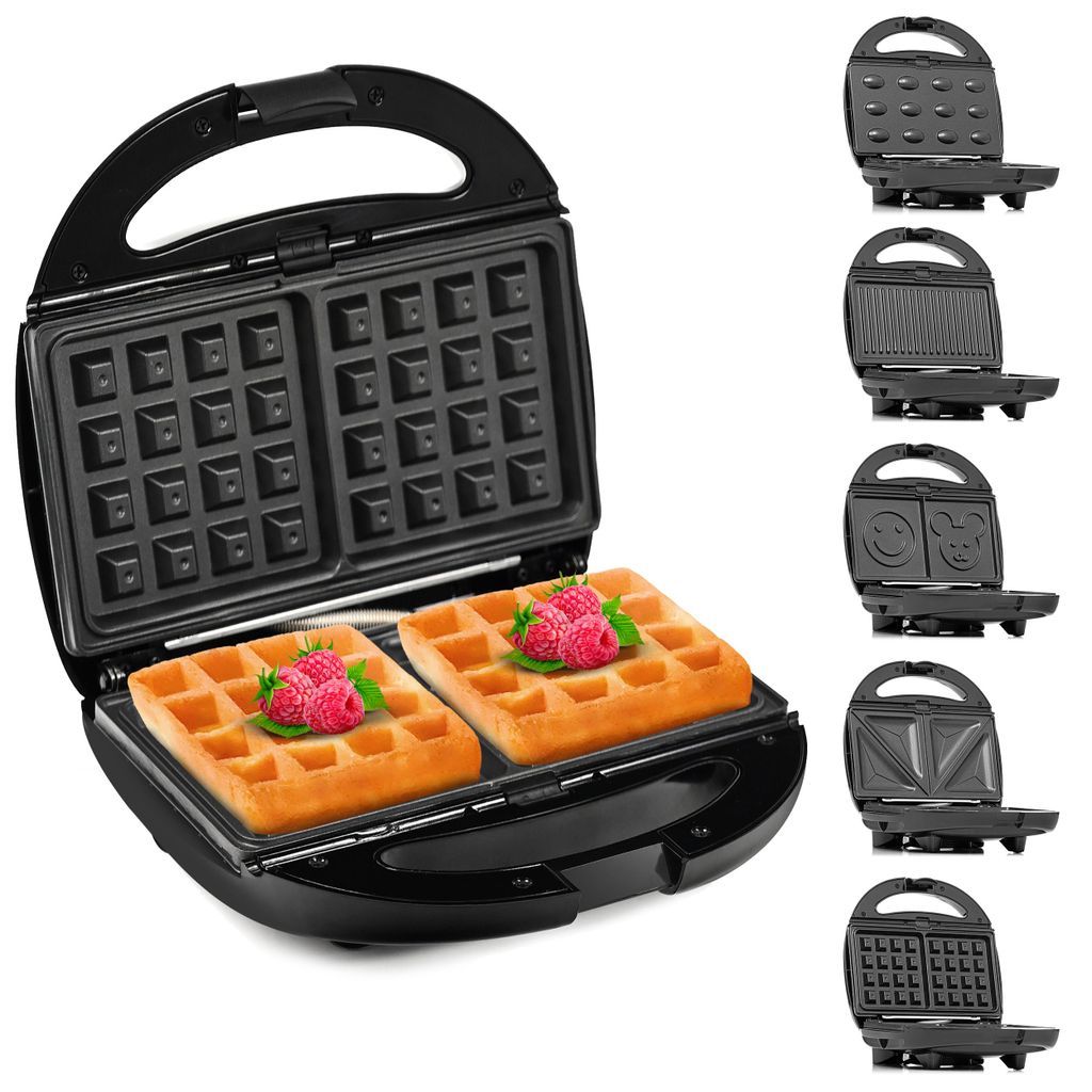 A black waffle maker shown open with two waffles inside, and several other interchangeable plates for different types of food displayed to the right.