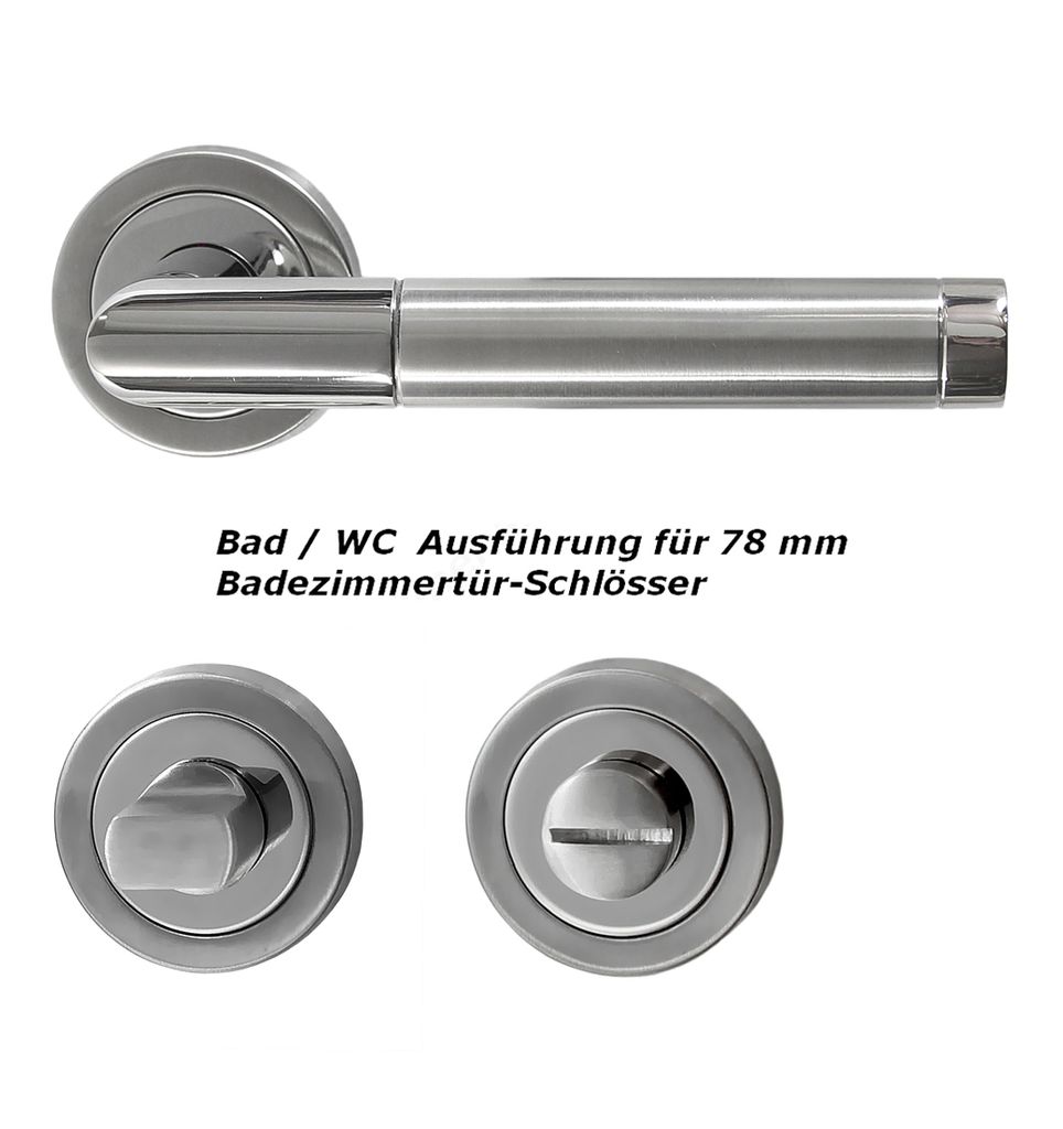 A set of stainless steel door handles and related hardware for a bathroom or WC door.