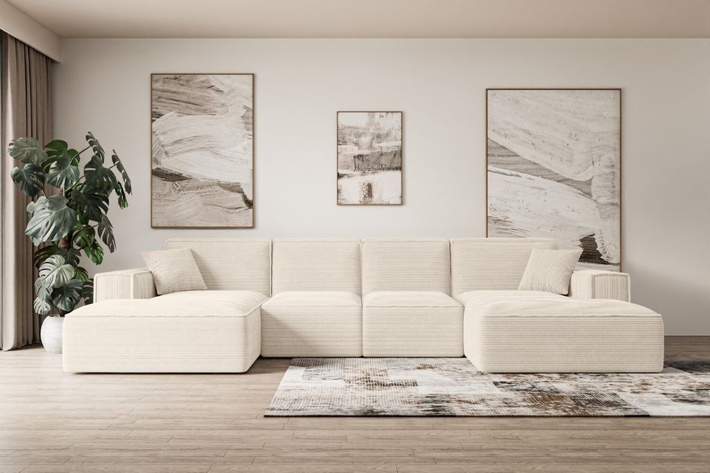A modern U-shaped sectional sofa in a cream color is arranged in a living room setting, accented by abstract art on the wall and a patterned rug.