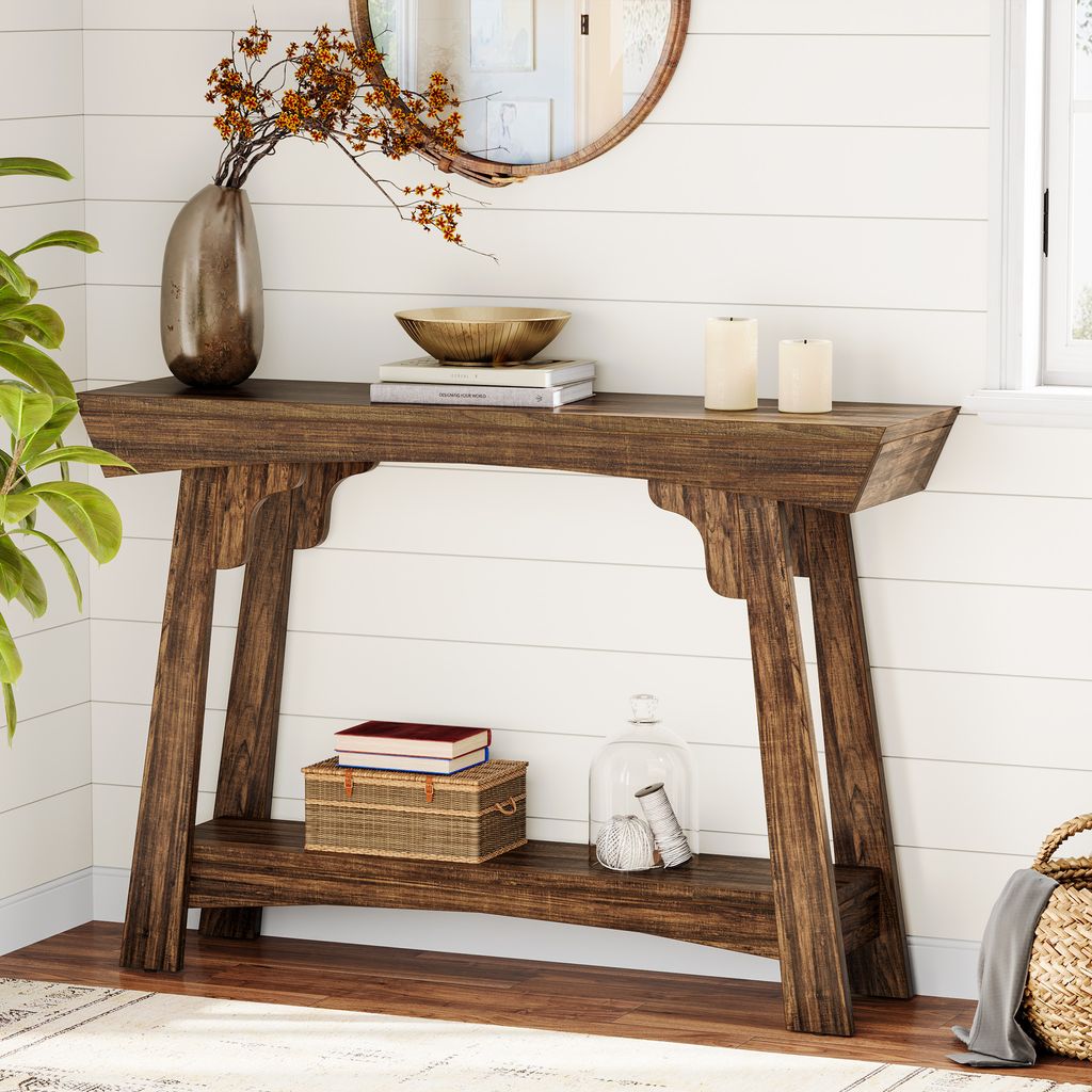 A wooden console table with decorative items in a room with white paneled walls.