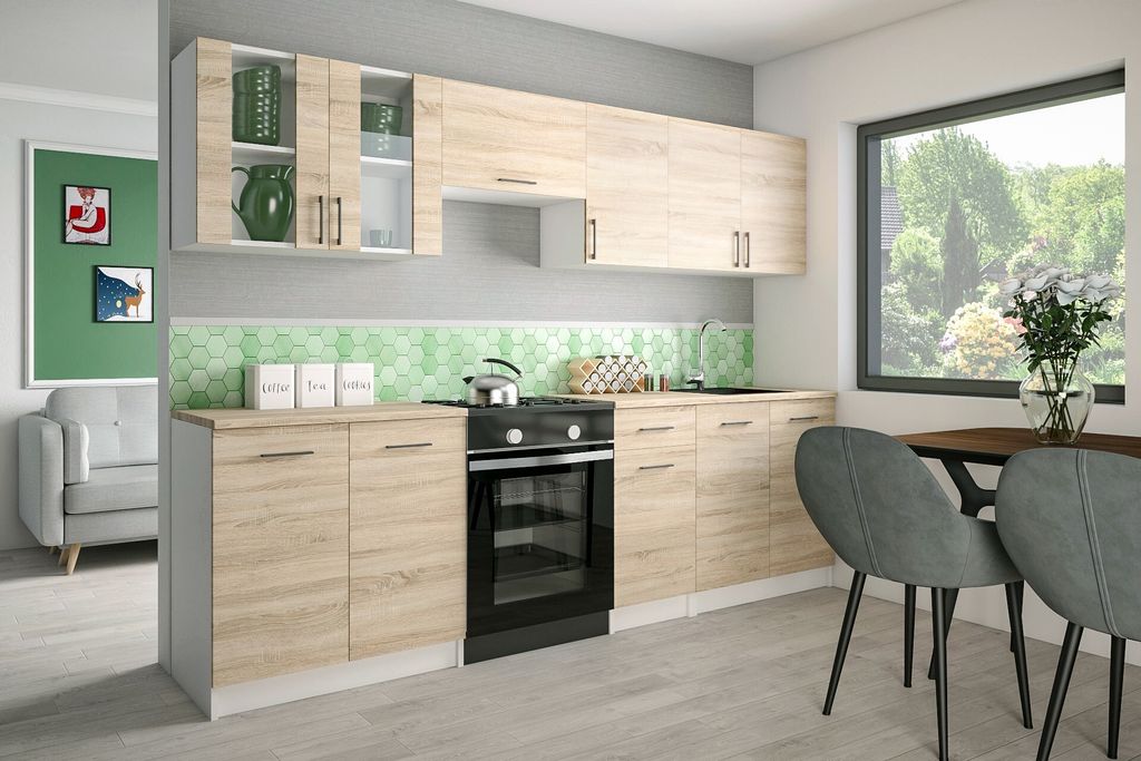 A modern kitchen setup with light brown cabinets, a black oven, and green hexagonal backsplash tiles.