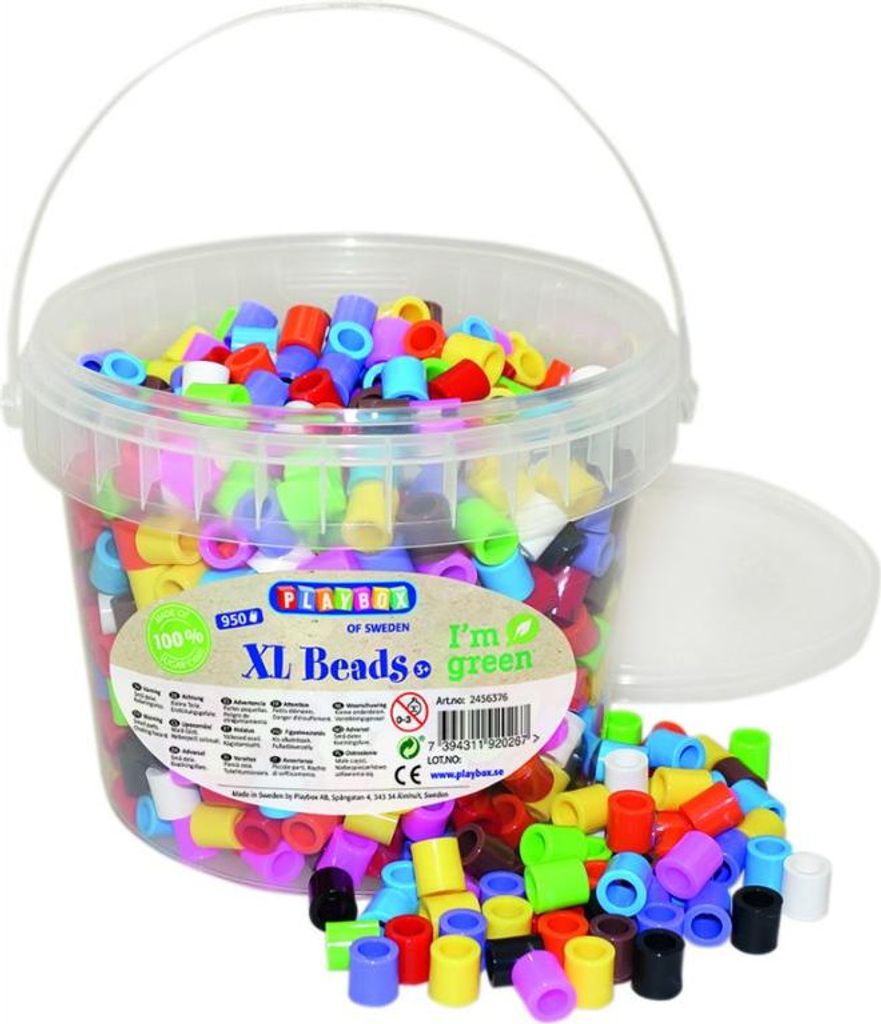 A bucket filled with colorful beads, with some spilled out onto a white surface.