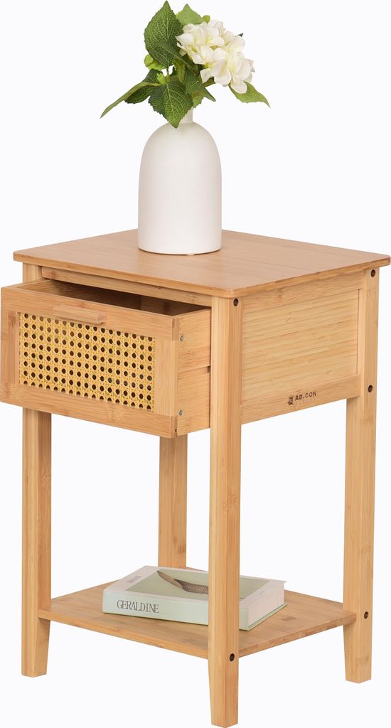 A wooden nightstand with a drawer and a shelf, topped with a white vase holding white flowers.