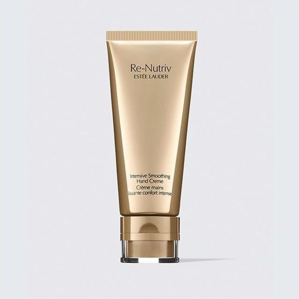 A gold-colored tube of Estée Lauder Re-Nutriv Intensive Smoothing Hand Creme is centered against a light gray background.