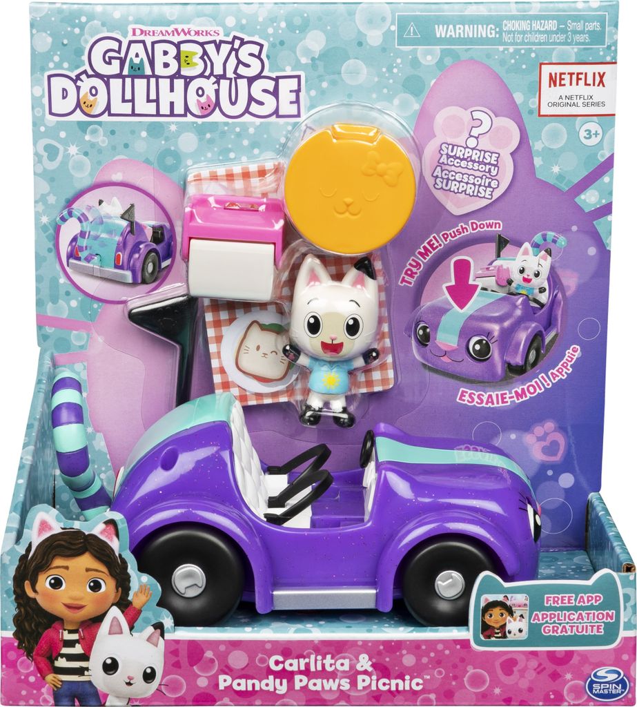 The image shows the packaging of a Gabby's Dollhouse toy set, featuring a purple vehicle, figures, and picnic accessories.