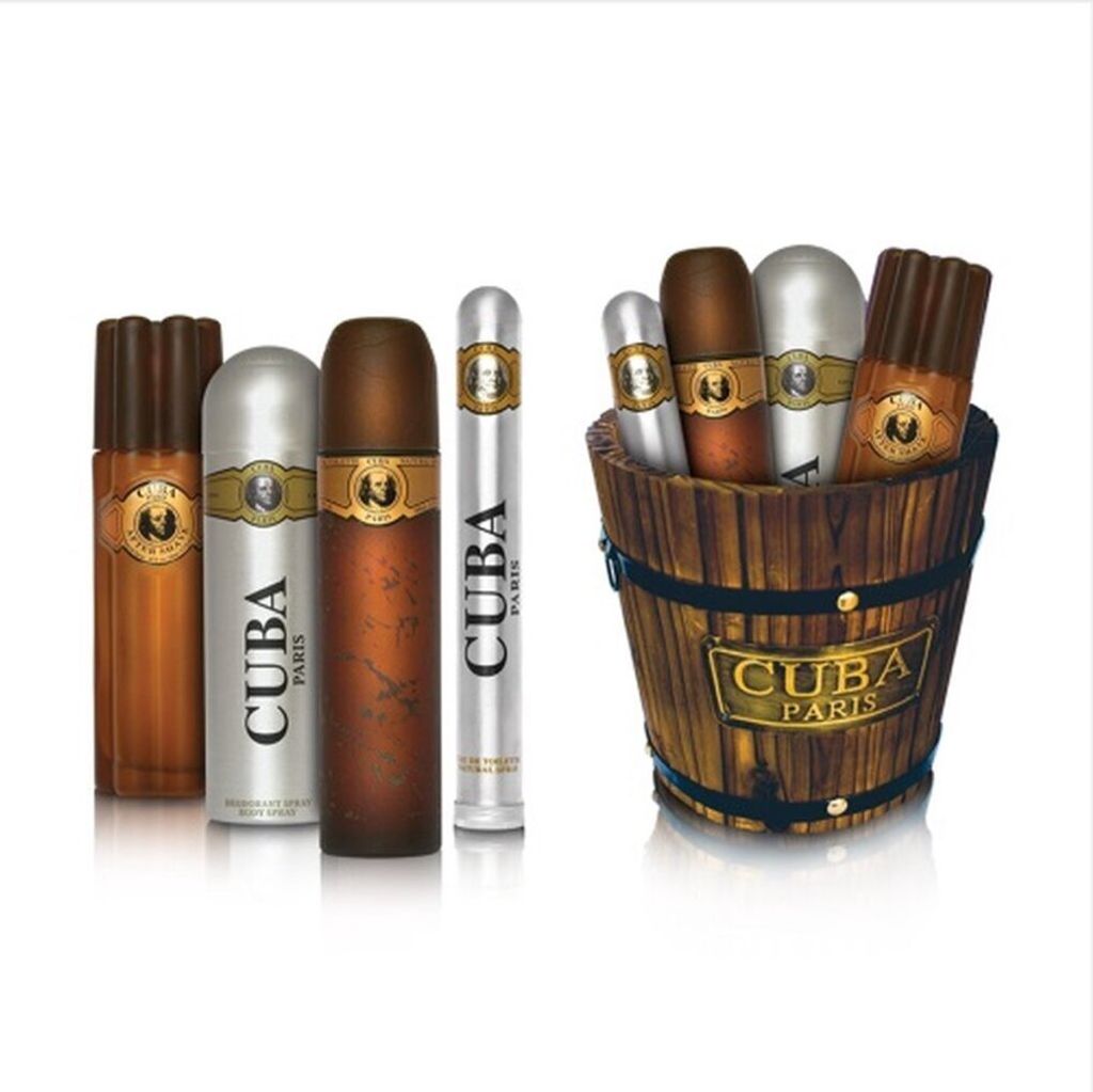 A collection of Cuba Paris branded fragrance products, including Eau de Toilette, After Shave, and Body Spray, displayed in a wooden bucket.