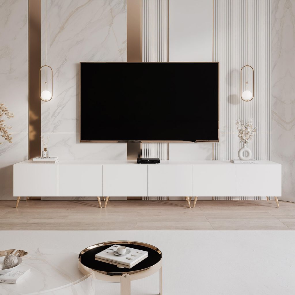 A white TV lowboard with gold legs in a modern living room setting.