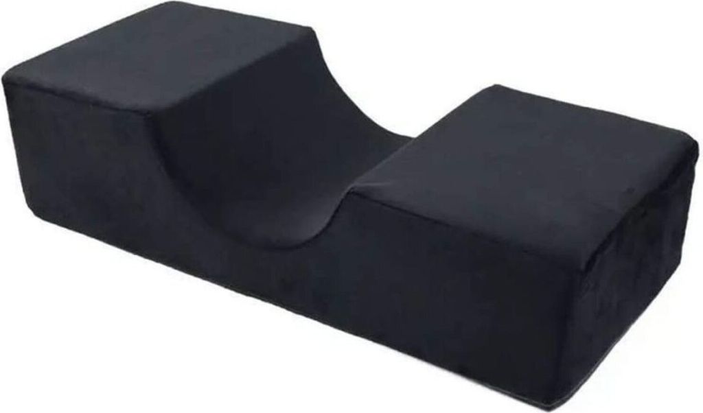 A black U-shaped pillow for eyelash extensions.