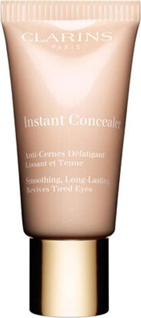A close-up studio shot of a Clarins Instant Concealer tube with a gold cap.
