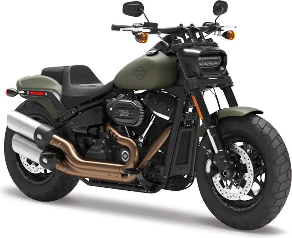 A studio shot of a green Harley Davidson Fat Bob 114 motorcycle against a white background.