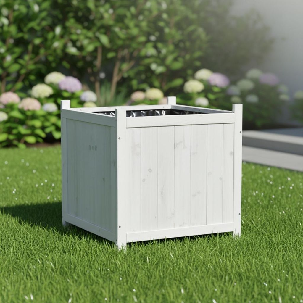 A white wooden planter box sits on a green lawn, with blurred green foliage and flowers in the background.