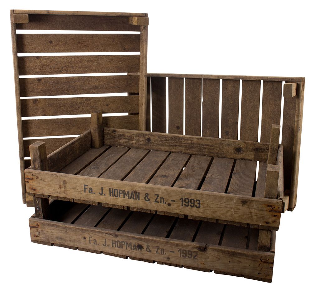 Three wooden crates are stacked and arranged in a way that suggests they are for display or storage.