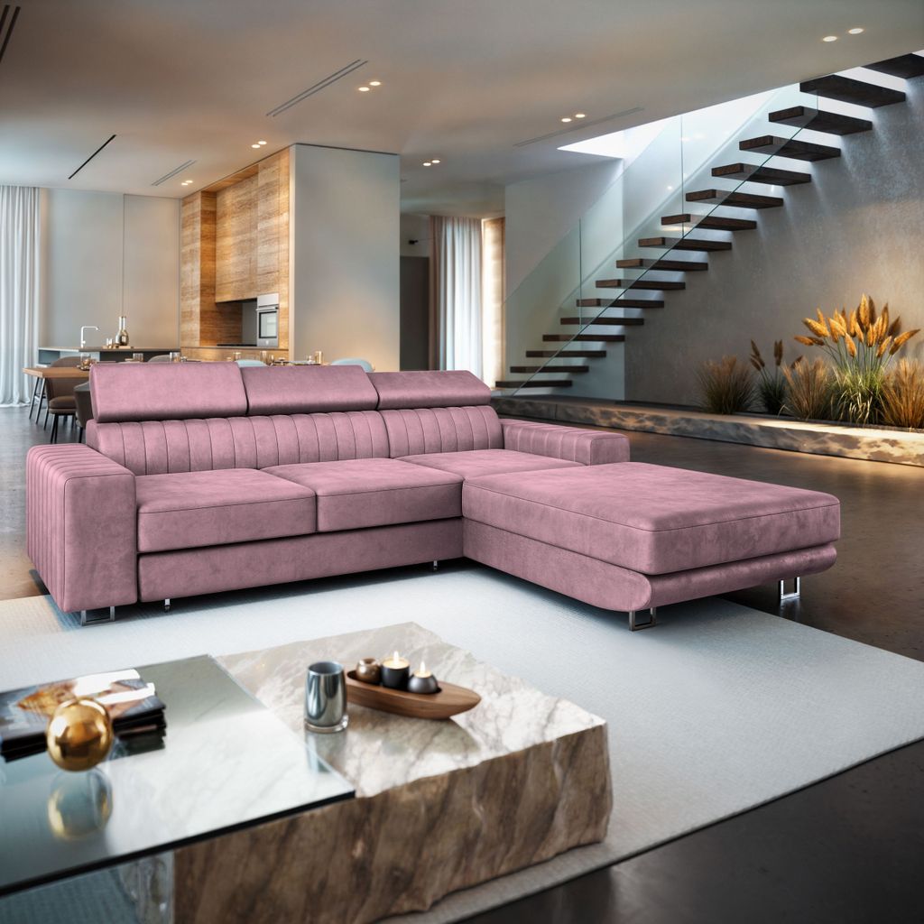 A pink sectional sofa in a modern living room with a staircase in the background.