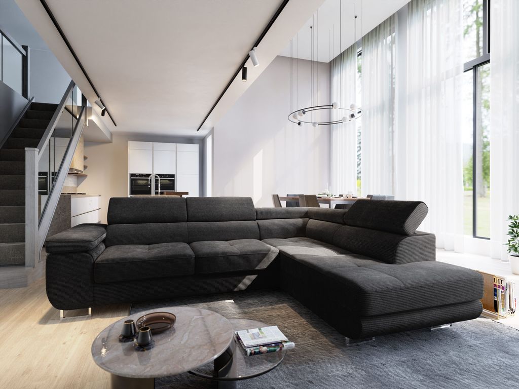 A modern living room with a large sectional sofa, a coffee table, and a dining area in the background. The room has high ceilings and large windows with sheer curtains.