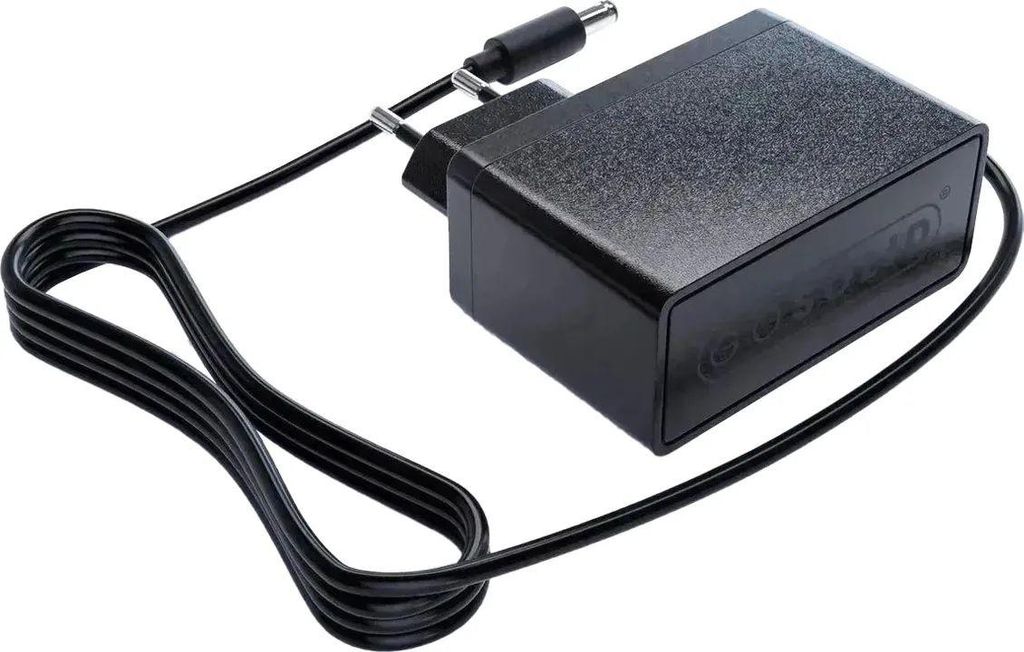A black power adapter with a coiled cord and a plug.