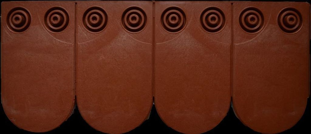 Four brown roof tiles arranged in a row against a black background.