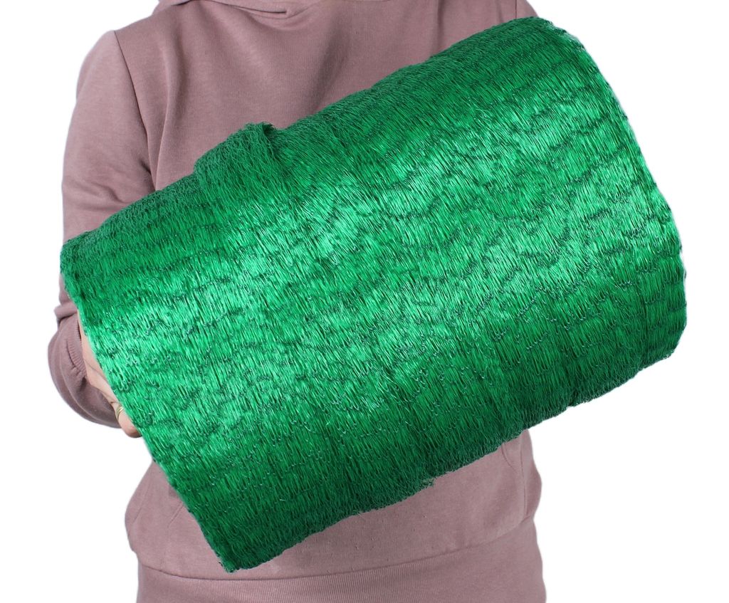 A person holding a rolled-up green net.