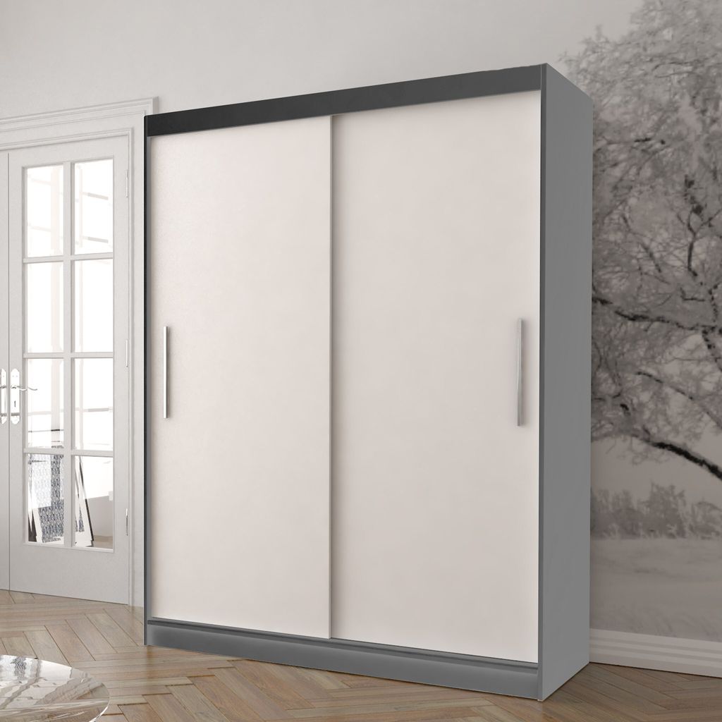 A sliding door wardrobe is shown in a room with a door and a wall with a tree pattern.
