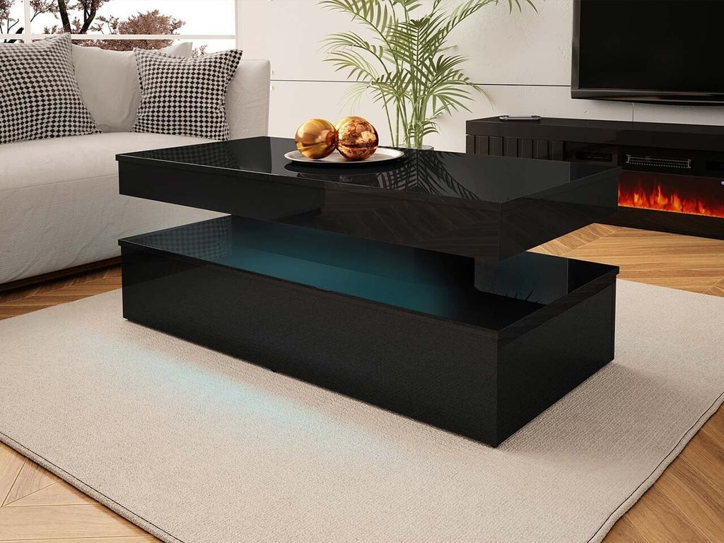A modern living room with a couch, coffee table, and fireplace.