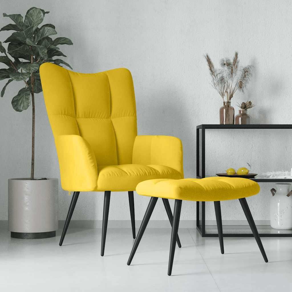 A yellow velvet armchair and ottoman are displayed in a room with a plant and a shelf with decorative items.