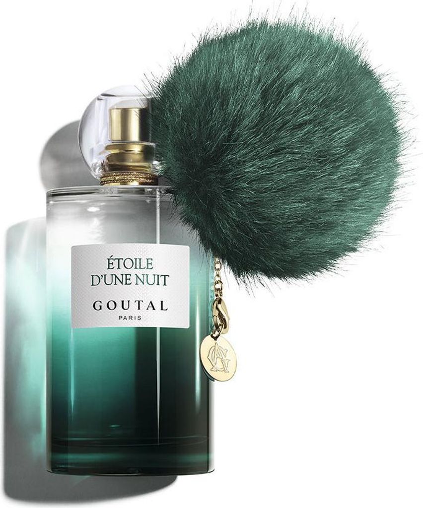 A perfume bottle with a fluffy green pom-pom accessory.