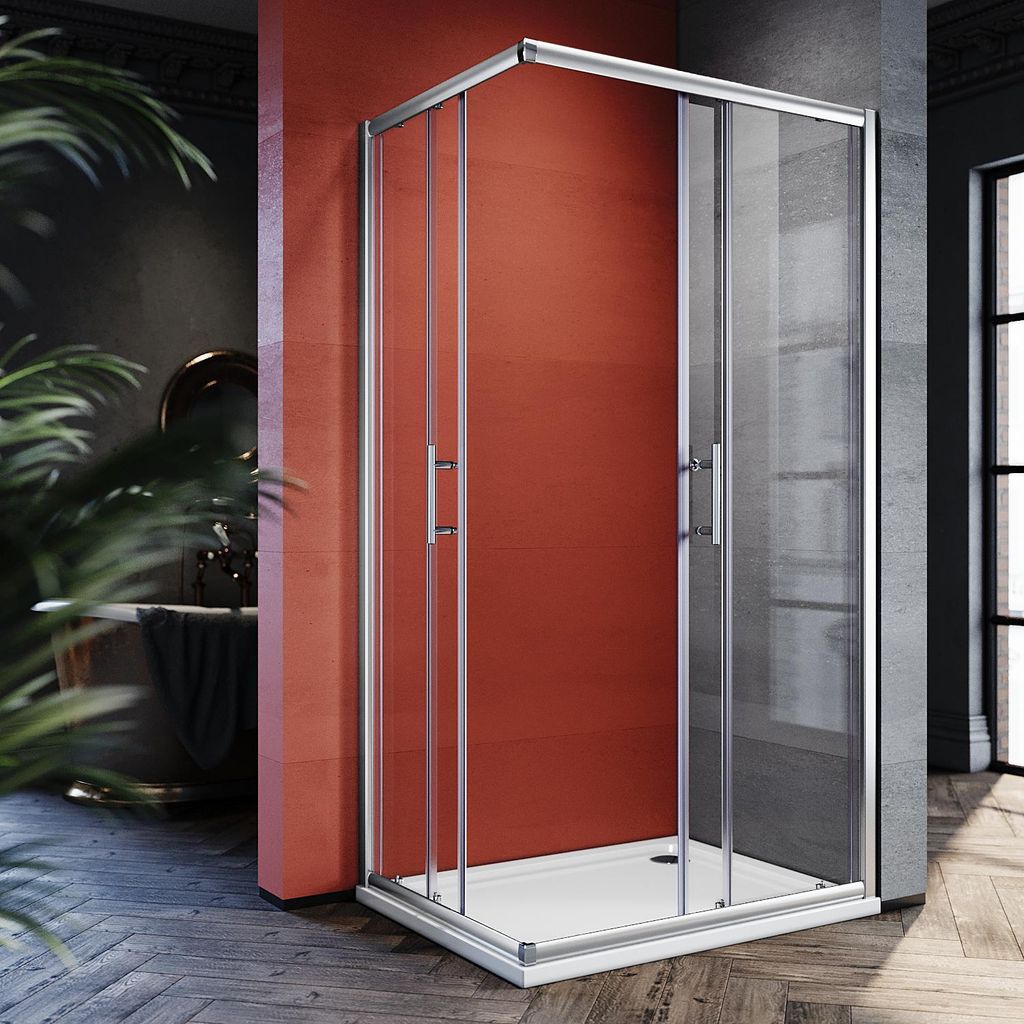 A modern bathroom with a red accent wall, featuring a glass shower enclosure.