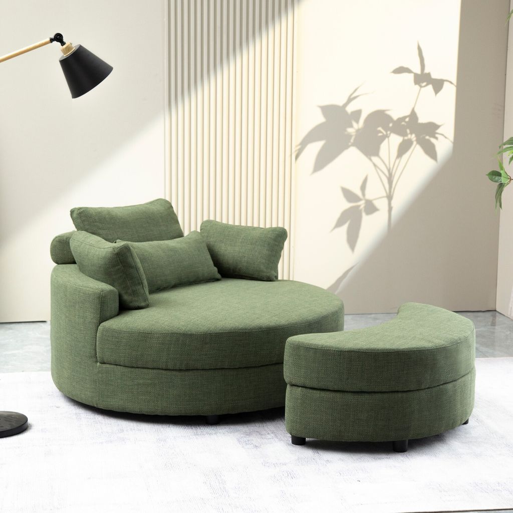 A modern green circular sofa with a matching ottoman in a well-lit room with a shadow of a plant on the wall.