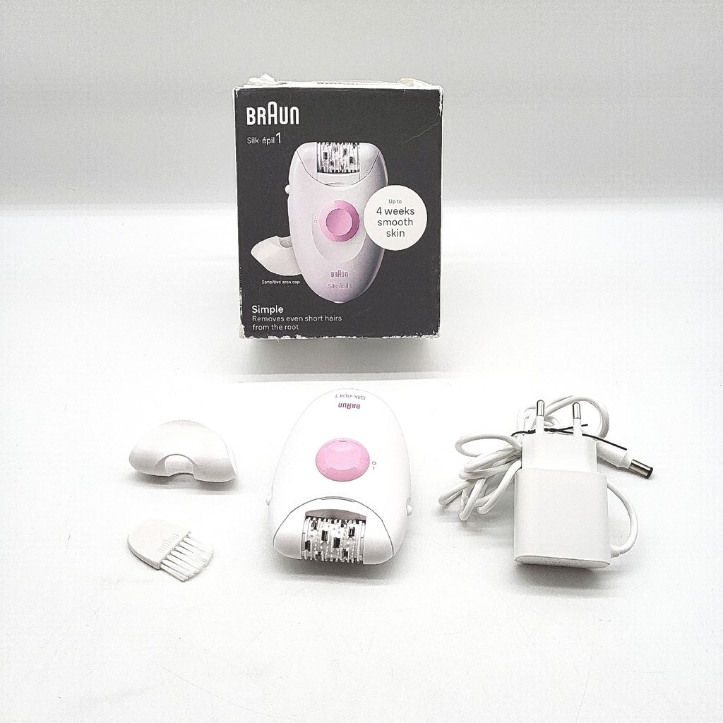 A Braun Silk Epil 1 epilator and its accessories are displayed on a white background, along with its packaging.