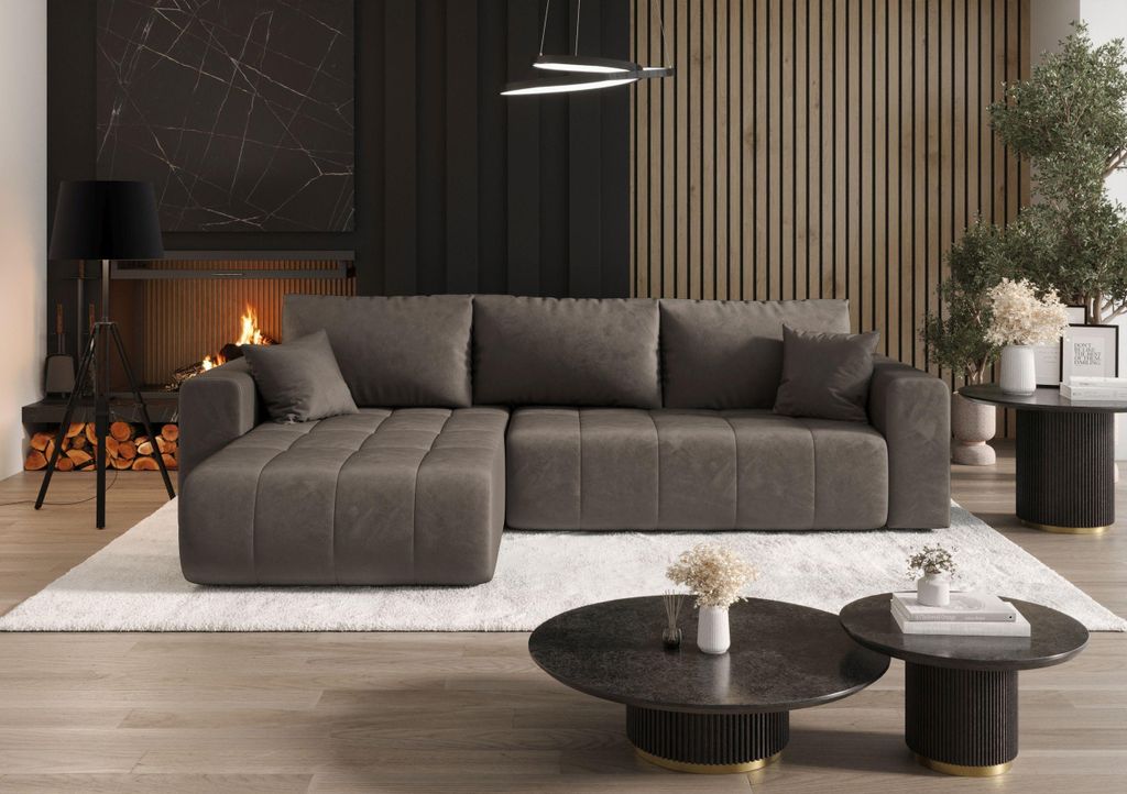 A modern living room with a fireplace, a sectional sofa, and coffee tables.
