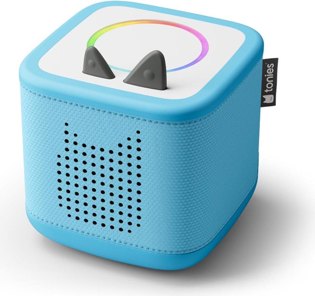 A blue Tonies Toniebox with cat ears and a rainbow light ring on top, shown from a slightly elevated front-left angle on a white background.