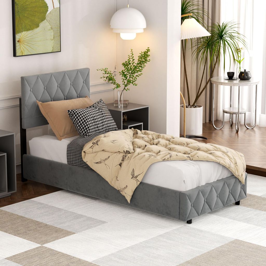 A bedroom scene featuring a single bed with bedding and pillows, a nightstand with a plant, and a floor lamp.