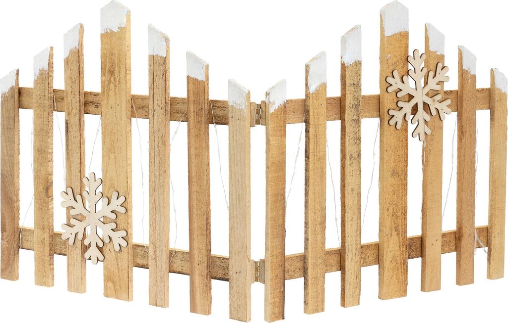 A wooden fence decoration with white tips and snowflake ornaments.