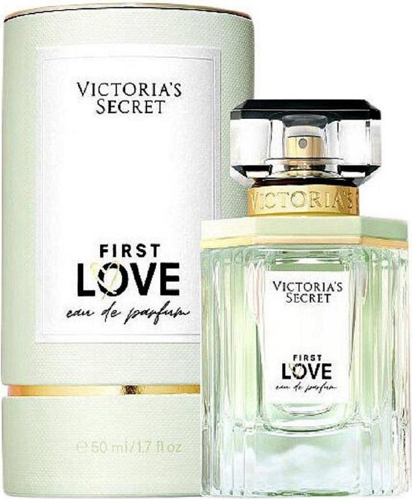 A bottle of Victoria's Secret First Love Eau de Parfum and its cylindrical packaging, both displayed against a white background.