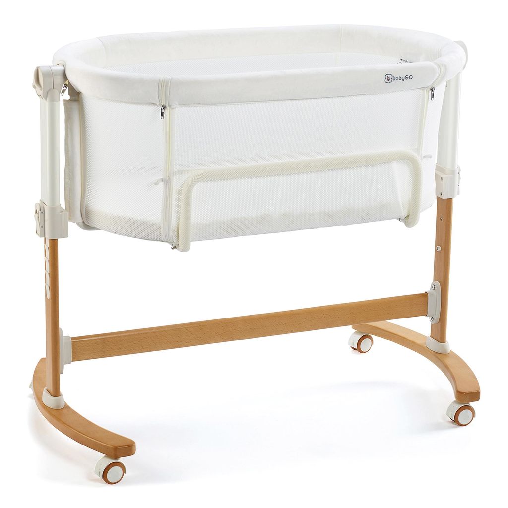 A white and wood baby bassinet on a white background.