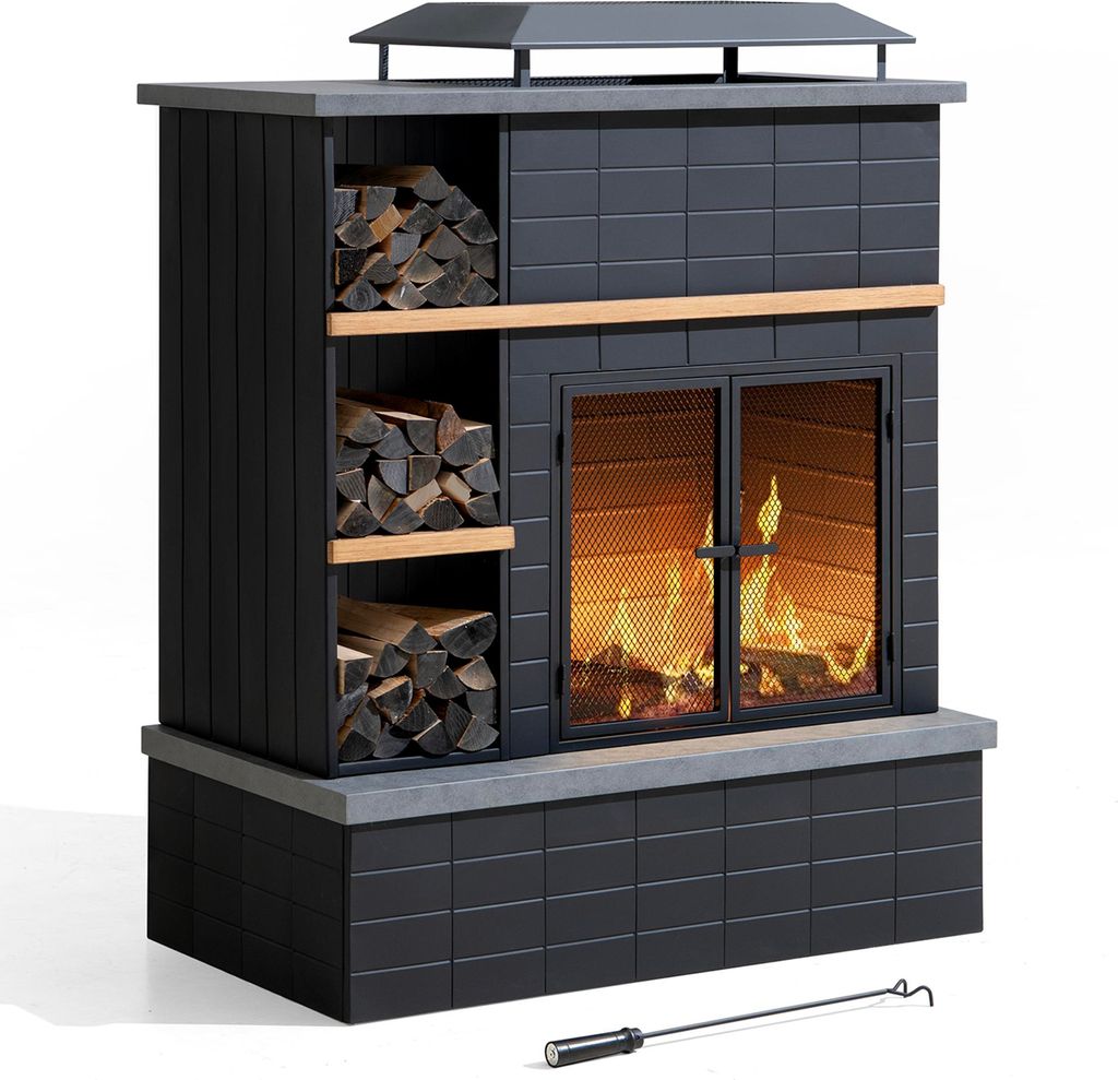 A black outdoor fireplace with wood storage on the left and a fire burning inside.