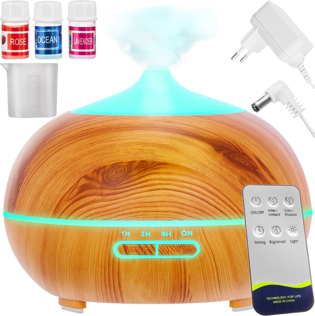 A product shot of an aroma diffuser with accessories and a remote control.