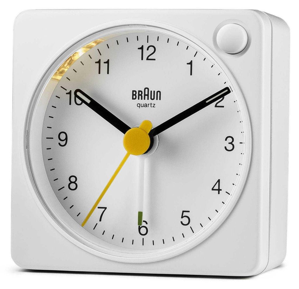 A white Braun alarm clock is shown against a white background.