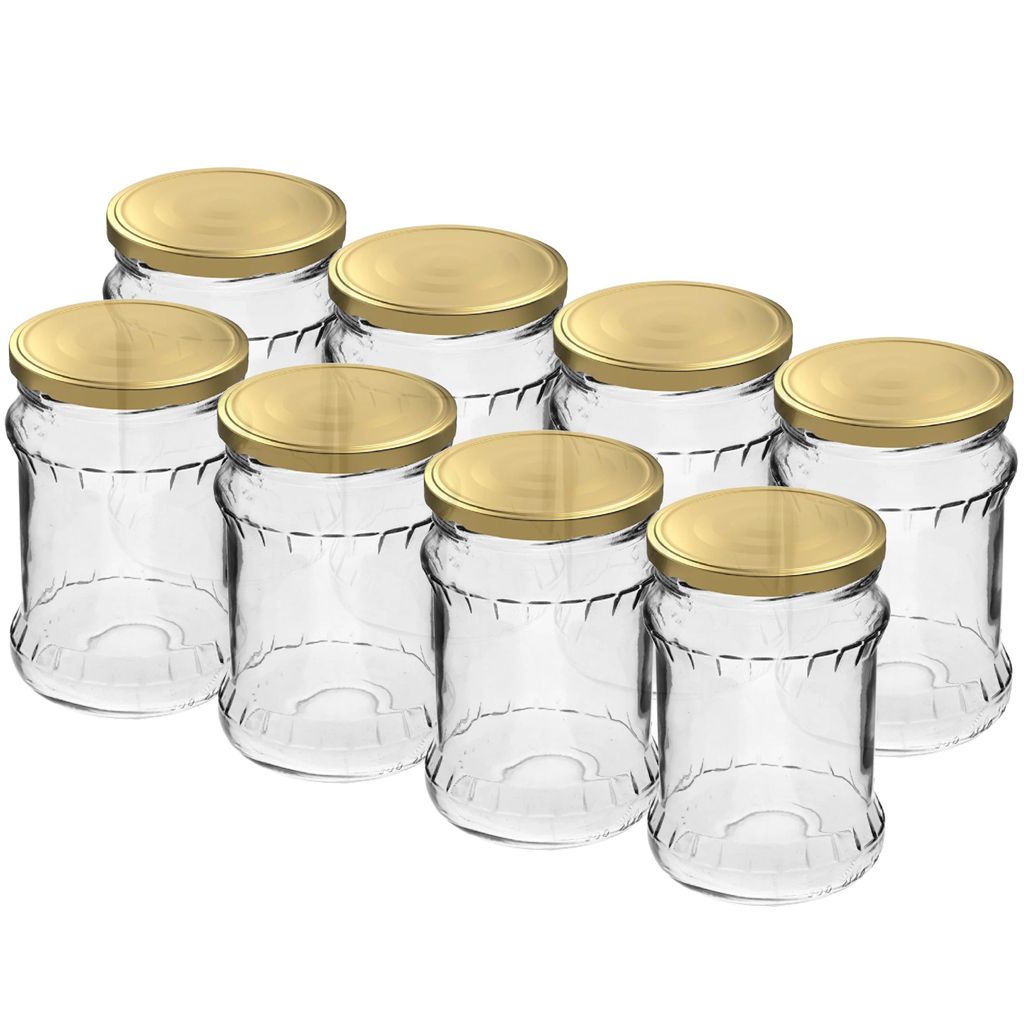 A group of empty glass jars with gold lids are arranged on a white background.