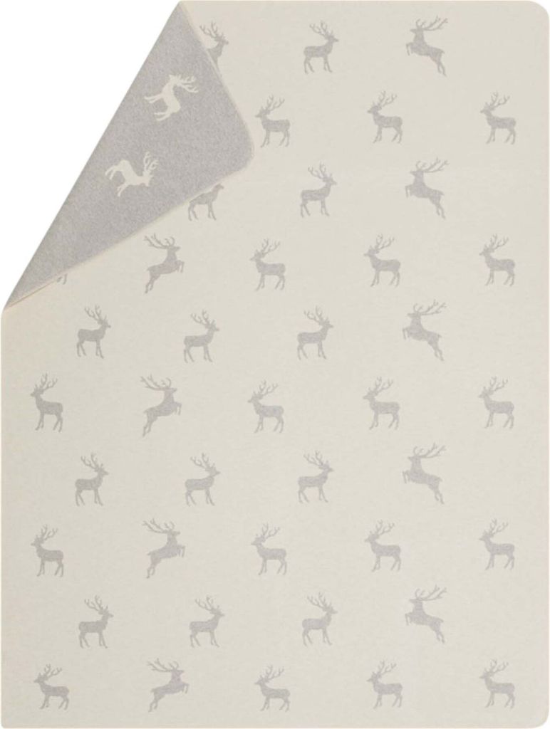 A folded blanket with a repeating pattern of reindeer. The blanket is shown from a slightly elevated angle, with one corner folded back to reveal the underside.