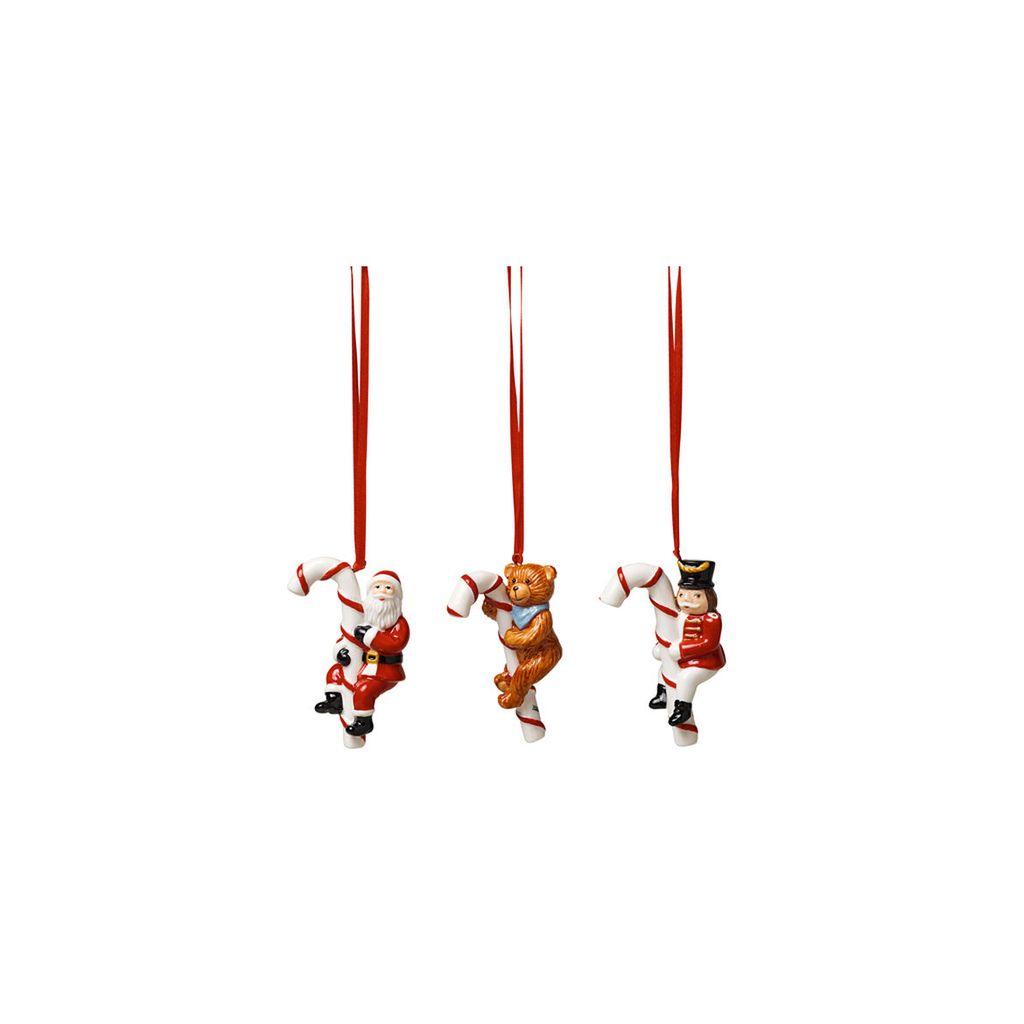 Three Christmas ornaments hanging from red ribbons against a white background.