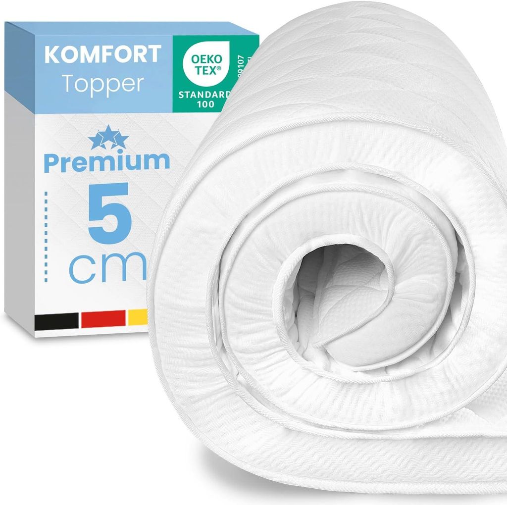 A rolled-up white mattress topper is shown next to its packaging.