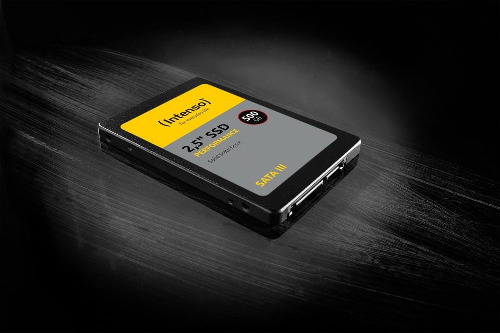 A 2.5" SSD is shown on a dark, textured surface with dramatic lighting.